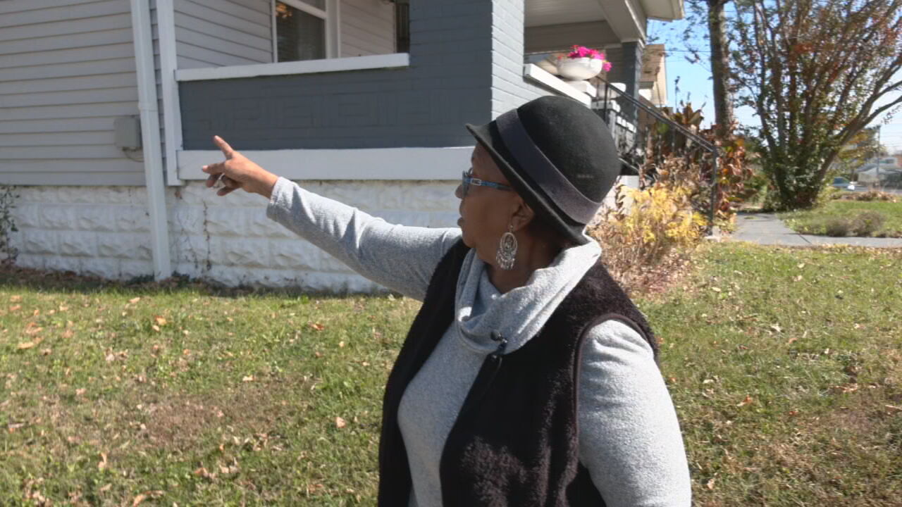 Quintella Pulliam points to a window in her home, saying she doesn't open it anymore because of the smell coming from the catch basin outside.